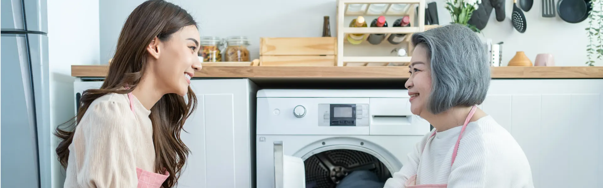 A female and an elderly woman doing the laundry